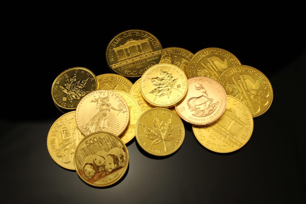 Image of a pile of foreign gold coins against a black background