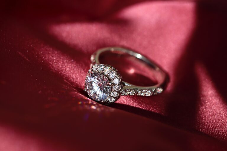 Diamond rings against a red fabric silk background.