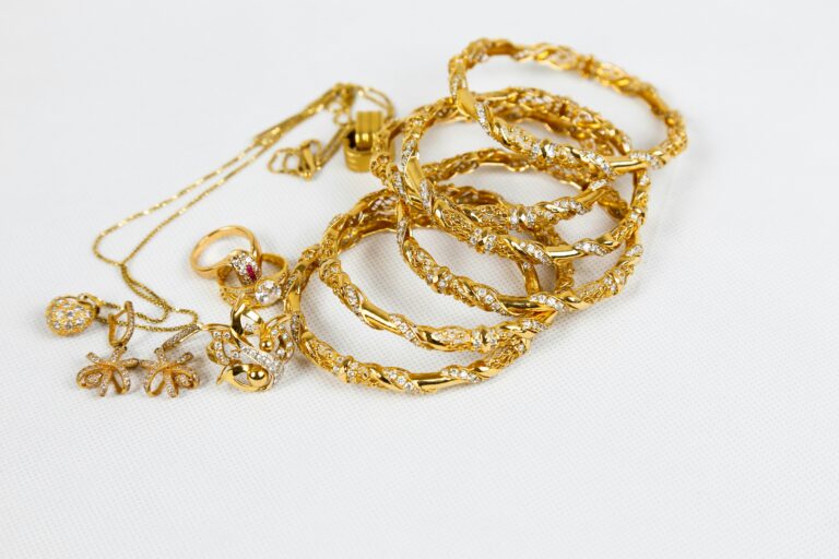 Image of fine gold jewelry laid against a white background.