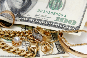 Image of gold jewelry set against cash. Cash for jewelry.