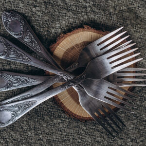 Set of silver forks arranged on table, We buy silver, we buy silverware.